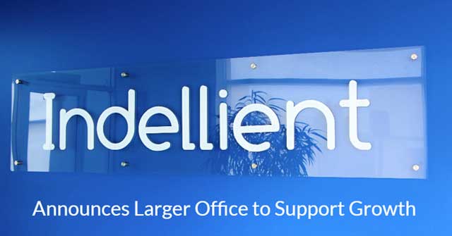 Photo of the Indellient sign against a light blue wall, taken in the Indellient Toronto office foyer