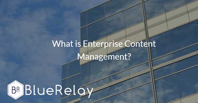 Image of the side of a building that has many mirrors, reflecting clouds