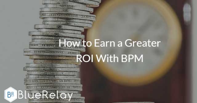 Closeup photo of different sized coins layered in a stack, with a yellow clock out of focus in the background