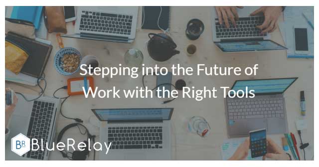 Photo of the top of a light, almost white, wood table with five laptops all being worked on by people.